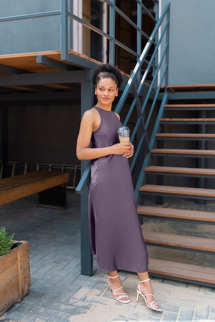 Free photo woman having an iced coffee break outside