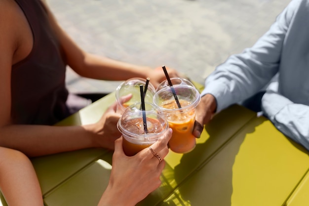 Free photo woman having an iced coffee break outside