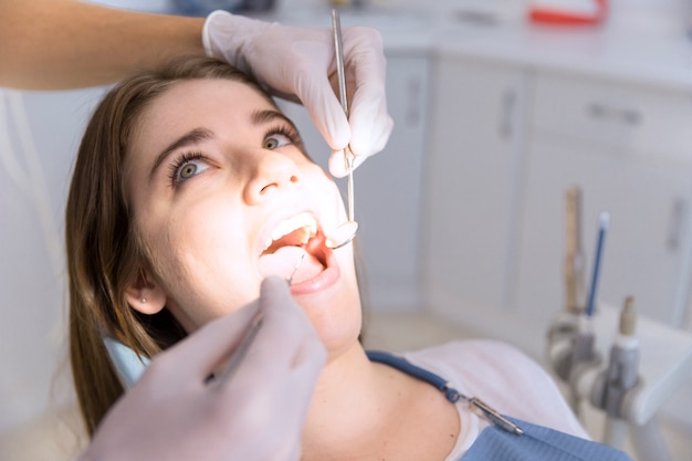 Woman having teeth examined at dentists