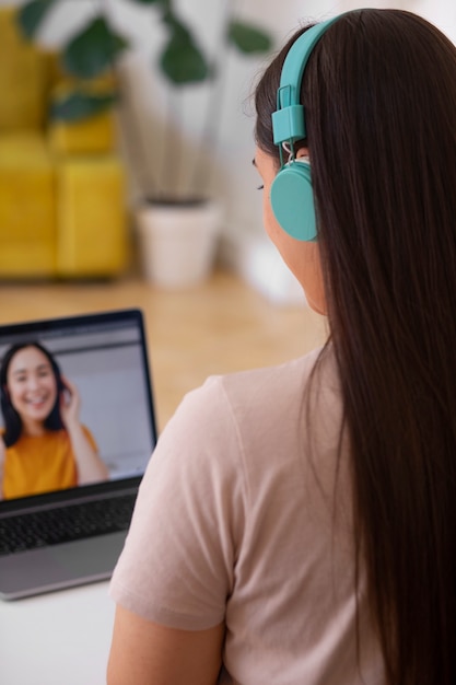 Free photo woman having a videocall using a laptop device from home