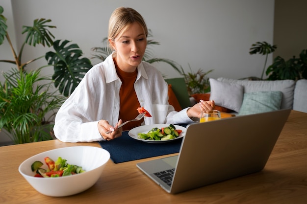 Free Photo woman having a videocall while eating