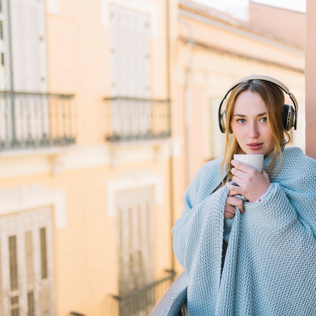 Woman in headphones looking at camera