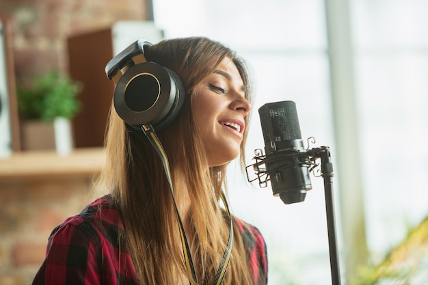 Woman in headphones recording music