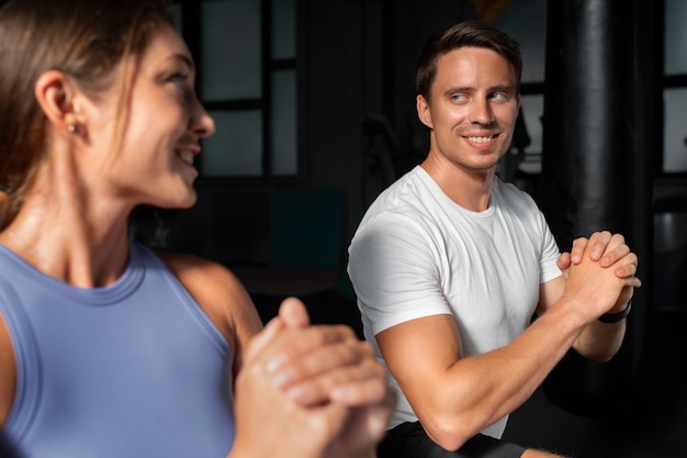 Free photo woman helping man at gym