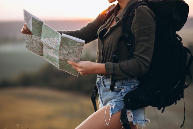 Free Photo woman hiking in the mountains and looking in the map