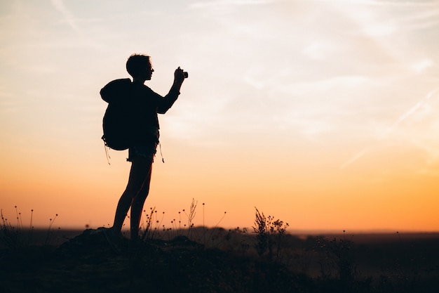 Free Photo woman hiking in the mountains and making photo