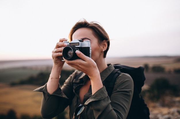 Free photo woman hiking in the mountains and making photo