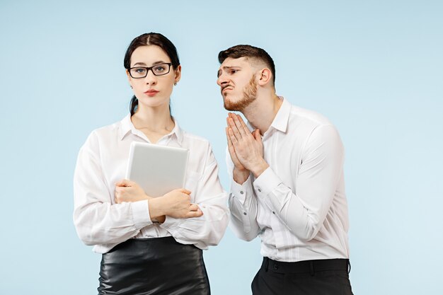 Woman and his secretary standing at office or studio. Businessman begging to his colleague. Office relationships concept, Human emotions