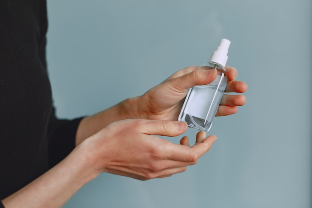 Woman holding antiseptic in her hands