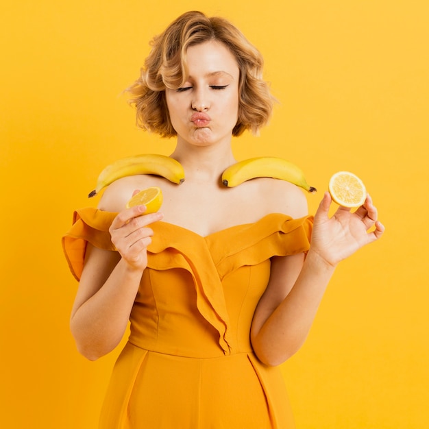 Woman holding bananas and lemon