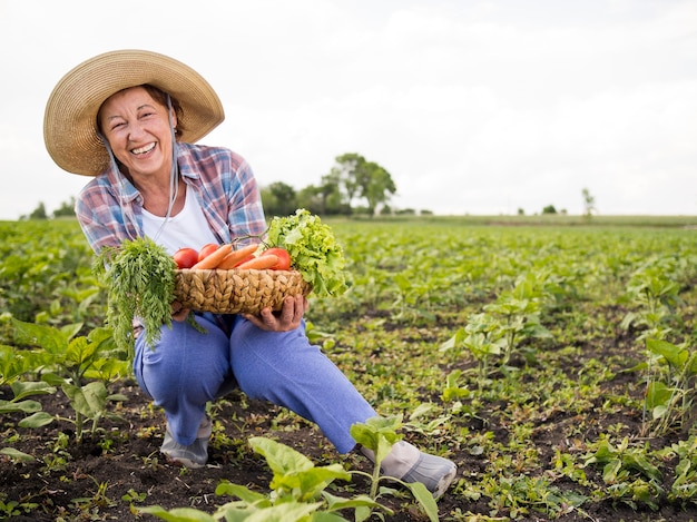 Woman holding a basket full of vegetables with copy space