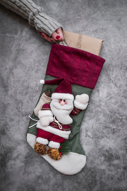 Free photo woman holding big christmas sock