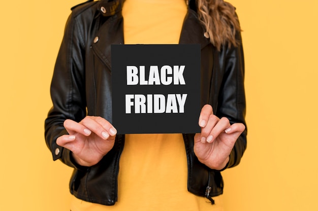 Free photo woman holding black friday label