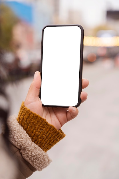 Woman holding a blank smartphone