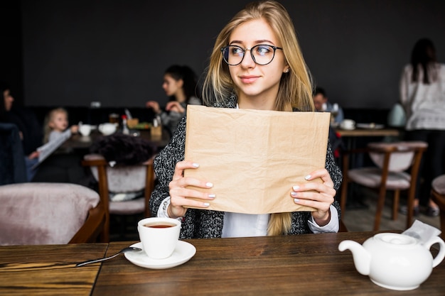 Woman holding book and looking away