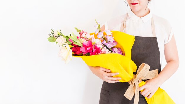 Woman holding bouquet of flowers on white background