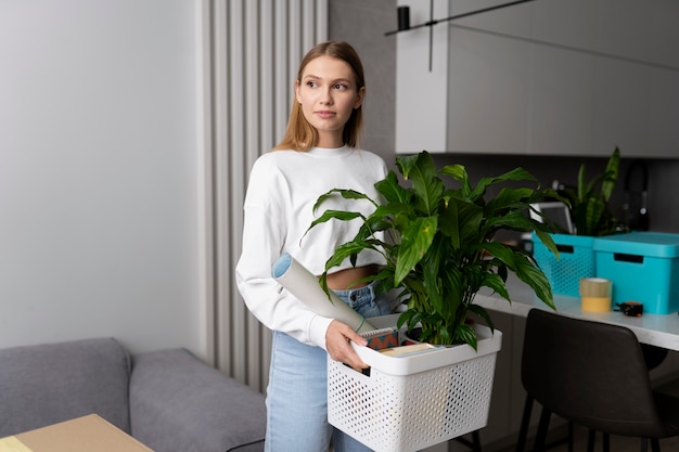 Free photo woman holding box of belongings