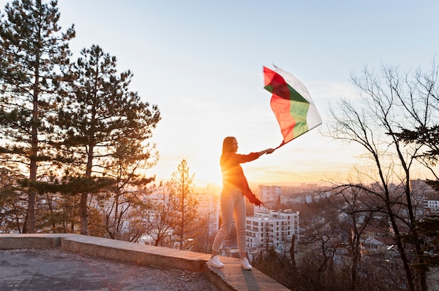 Woman holding bulgarian flag outdoors