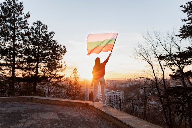 Woman holding bulgarian flag outdoors