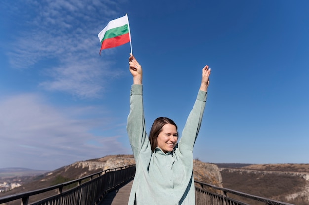 Woman holding bulgarian flag outside