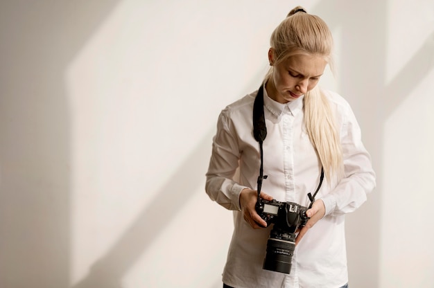 Free photo woman holding a camera photo