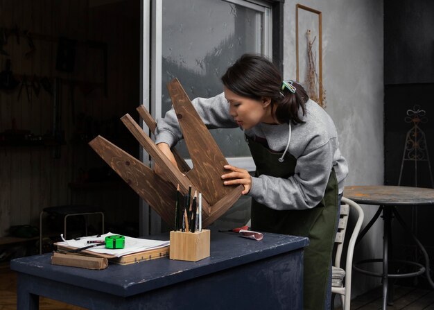 Woman holding chair medium shot