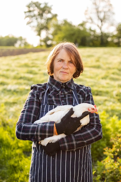 Woman holding a chicken