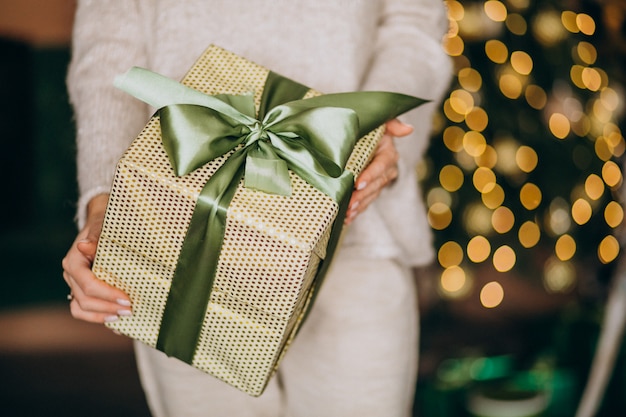 Woman holding a Christmas present, box close up