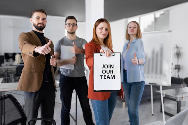 Woman holding a clipboard with join our team message