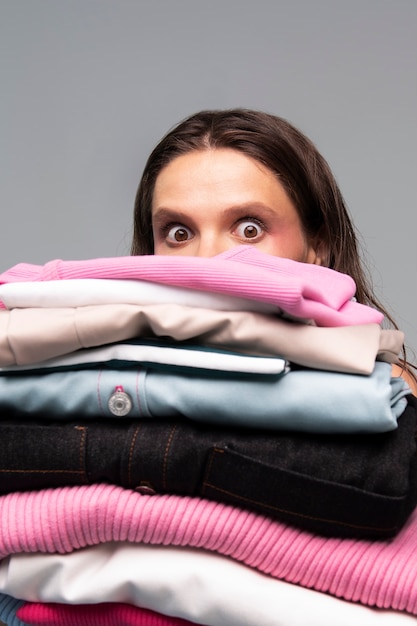 Woman holding clothes front view