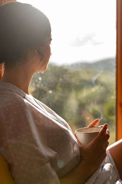 Free Photo woman holding coffee cup medium shot