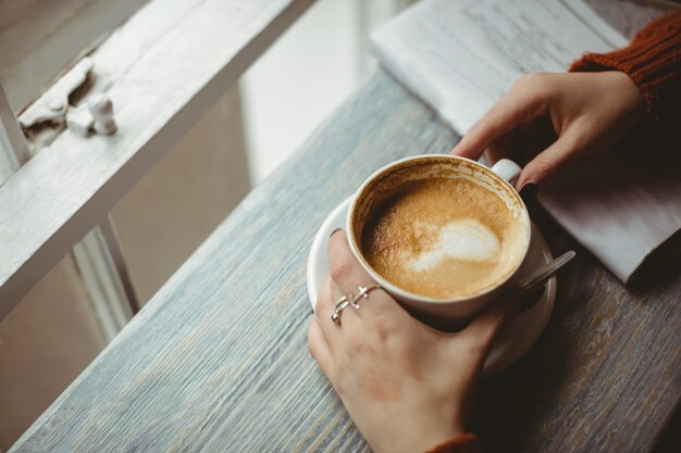 Woman holding coffee cup