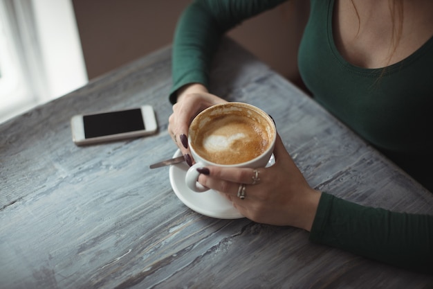 Woman holding coffee cup