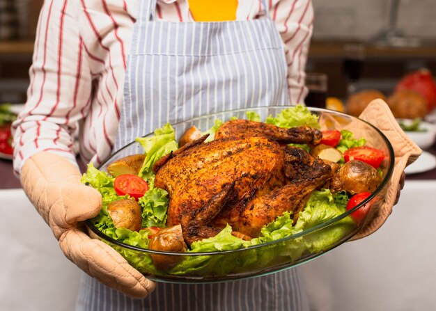 Woman holding the cooked turkey close-up