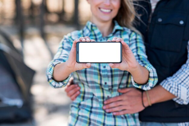 Woman holding copy space mobile phone