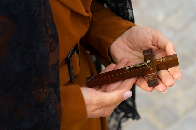 Free Photo woman holding a crucifix at church