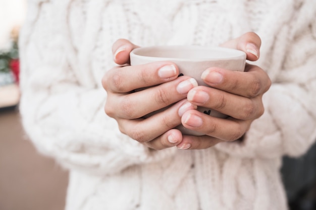 Free Photo woman holding cup of coffee