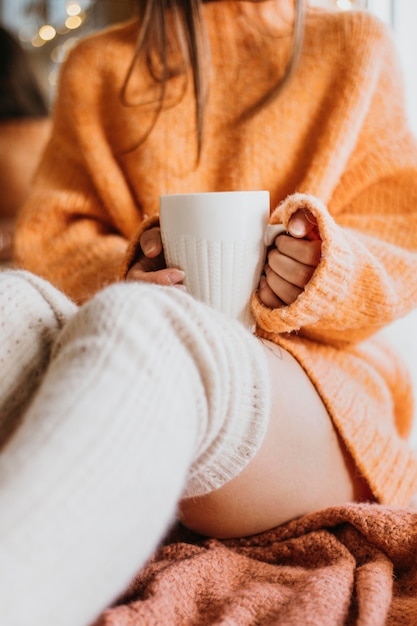 Free Photo woman holding a cup of tea at home