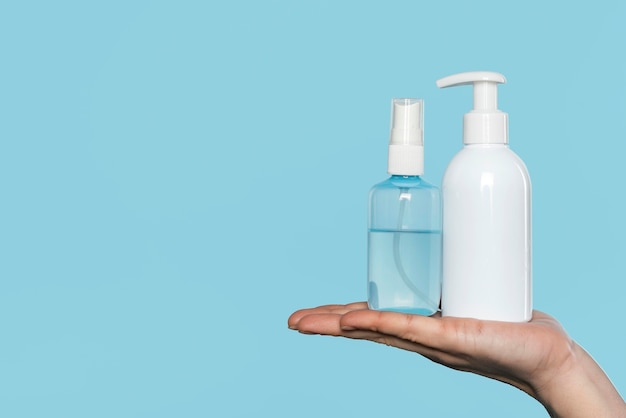 Woman holding disinfectant bottles