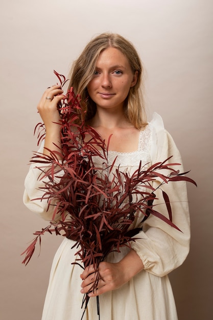 Free photo woman holding dried plants front view