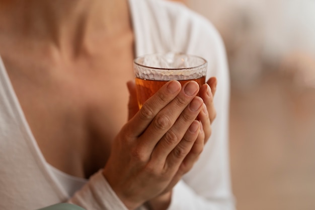 Free photo woman holding drink front view