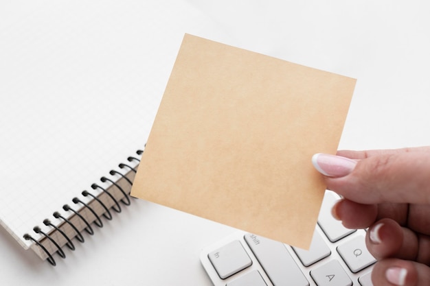 Woman holding an empty post it