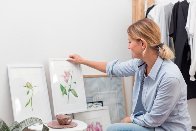 Free Photo woman holding flower painting