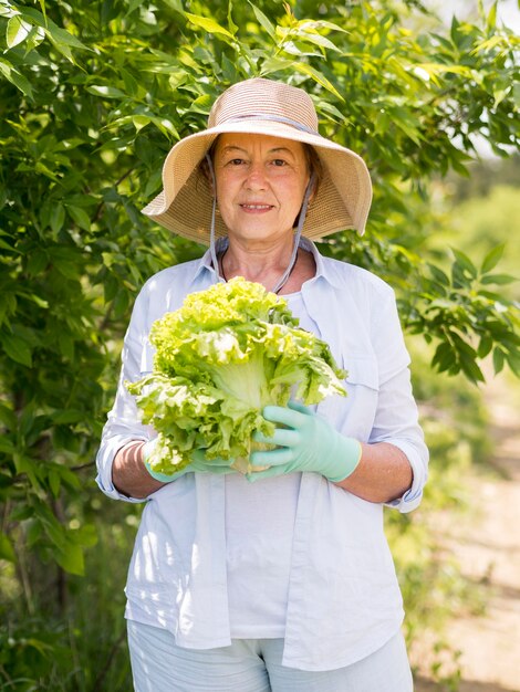 Woman holding a fresh cabbage in her hands