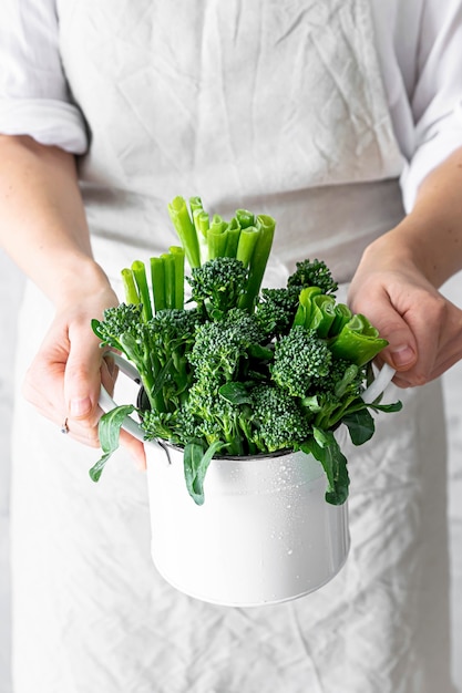 Woman holding fresh organic broccoli