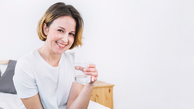 Woman holding glass of water