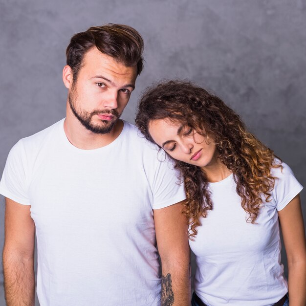 Woman holding head on man shoulder