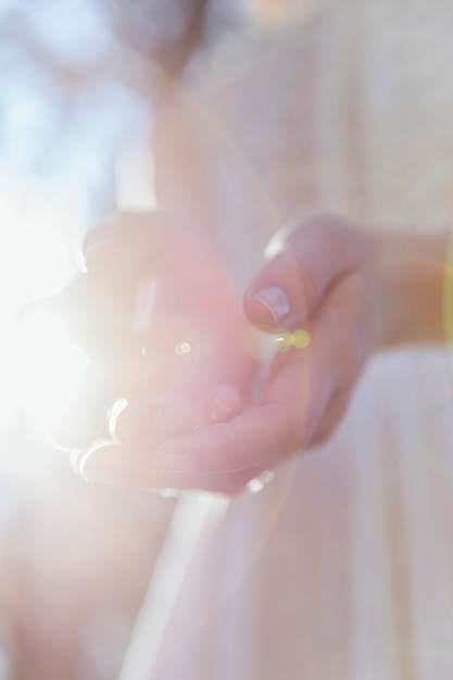 Free photo woman holding her hands in sunlight