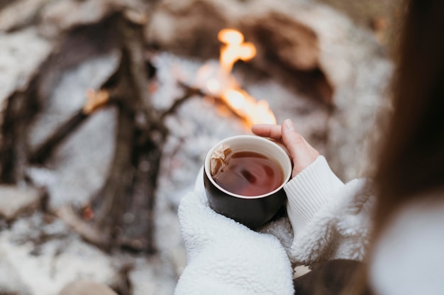 Free Photo woman holding a hot cup of tea