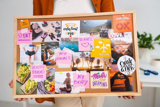 Free Photo woman holding inspiring vision board front view